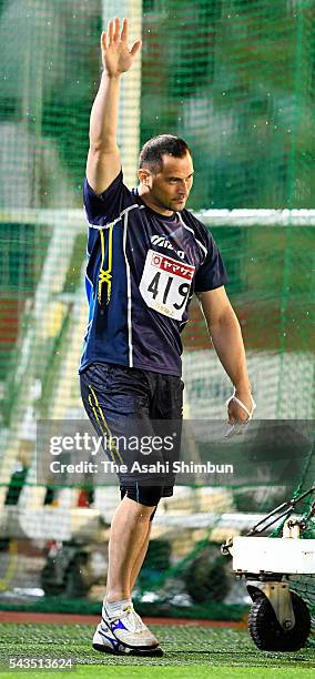 Koji Murofushi applauds the fans after competing in the Men's Hammer Throw qualification during day one of the 100th Japan National Athletic...