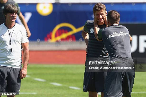Lukas Podolski of Germany jokes with his team mate Thomas Mueller during a Germany training session at Ermitage Evian on June 29, 2016 in...