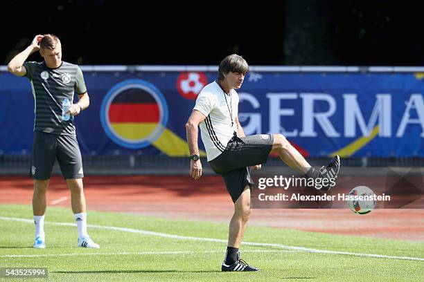 Joachim Loew, head coach of Germany plays with the ball next to his player Toni Kroos during a Germany training session at Ermitage Evian on June 29,...