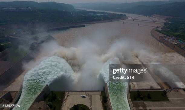 Water is released from the floodgates of the Xiaolangdi dam on the Yellow River near Luoyang, in China's Henan province on June 29, 2016. - The...
