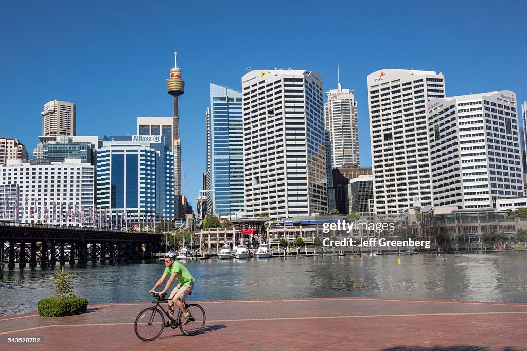 Australia, Sydney, Cockle Bay Promenade Wharf city skyline biking Pyrmont Bridge pedestrian