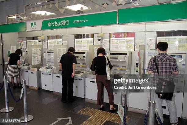 Japan Tokyo Shinjuku Post Office JP Bank kanji hiragana katakana characters symbols Japanese English customers ATM.