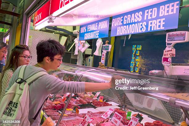 Australia, Victoria Melbourne Central Business District CBD Queen Victoria Market vendor stall selling buying sale butcher meats display case counter...