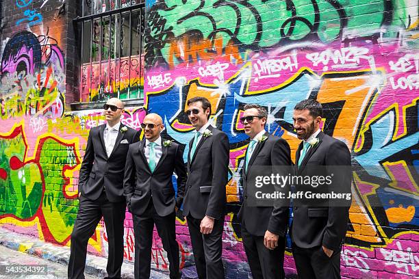 Australia, Victoria Melbourne Central Business District CBD Hosier Lane urban street art murals graffiti backdrop wedding photos groomsmen ushers...