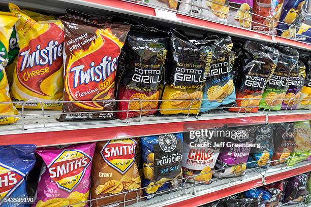 Australia, Sydney, Central Business District CBD convenience store shelves food junk snack potato chips bags competing brands packaging sale retail...