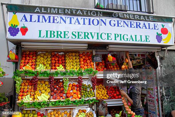 France Europe French Paris 9th arrondissement Place Pigalle produce vendor fruit display for sale small business front entrance.