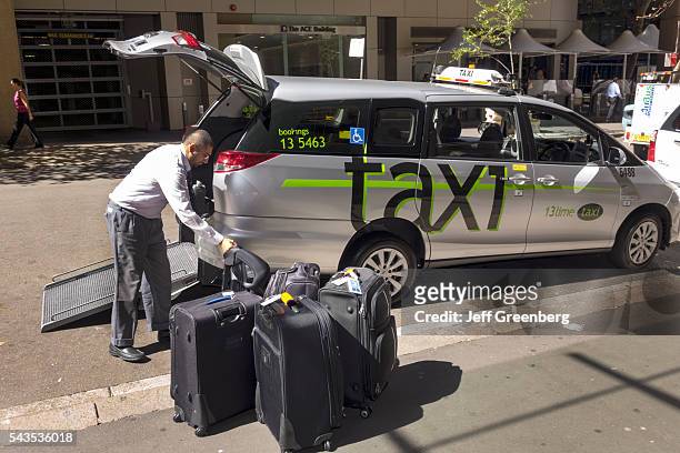 Australia, Sydney, CBD Central Business District taxi cab van man driver loading luggage.