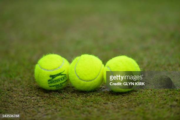 Tennis balls sit on a court on the third day of the 2016 Wimbledon Championships at The All England Lawn Tennis Club in Wimbledon, southwest London,...