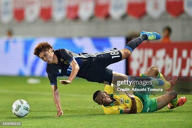 Junya Ito of Japan is challenged by Mothiba Mvalo of South Africa during the U-23 international friendly match between Japan and South Africa at the...