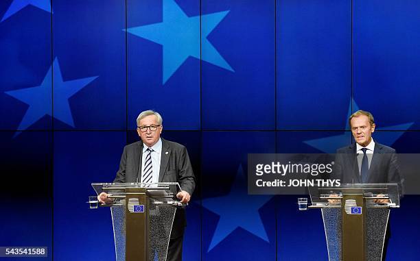 Commission President Jean-Claude Juncker gives a press conference with EU Council President Donald Tusk during a EU Summit meeting at the EU...
