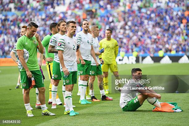 Robbie Keane, Seamus Coleman and Shane Long of Republic of Ireland show their disappointmen after defeat in the UEFA Euro 2016 match between France...