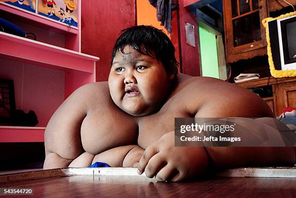 Arya Permana 10-year-old who weights 192 kilograms playing game in his home on June 13, 2016 in West Java, Indonesia. A 10-YEAR-OLD from Indonesia...