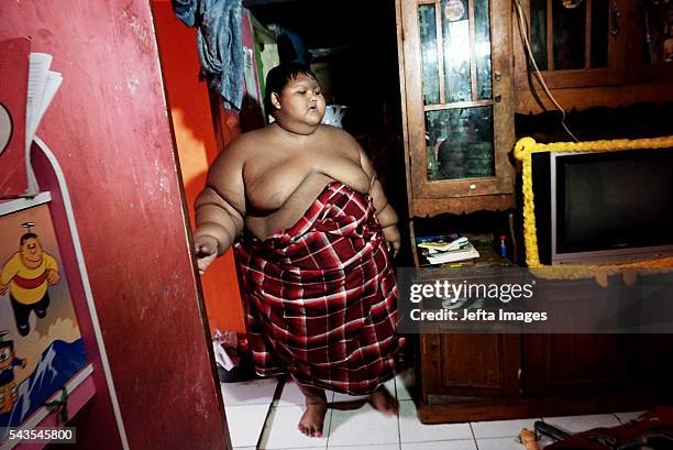 Arya Permana 10-year-old who weights 192 kilograms walk in his home on June 13, 2016 in West Java, Indonesia. A 10-YEAR-OLD from Indonesia has...