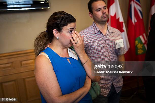 Linda and David Galvao gets emotional after the Minister of Children and Youth Services, Michael Coteau, addresses the media and parents at Queen's...