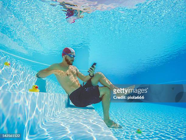 addicted to social networking: with mobile phone underwater - time off work stock pictures, royalty-free photos & images