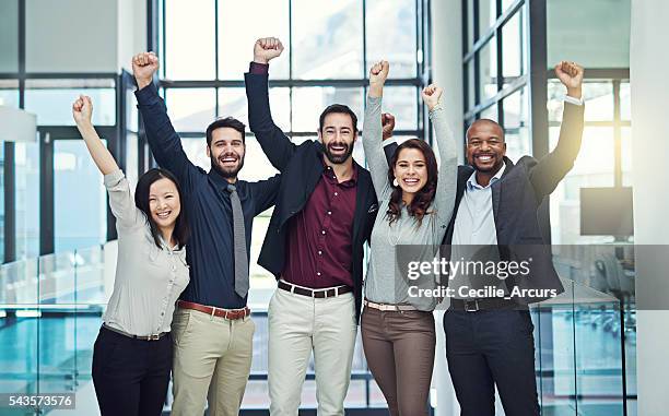 positive teams produce positive outcomes - business people cheering in office stockfoto's en -beelden