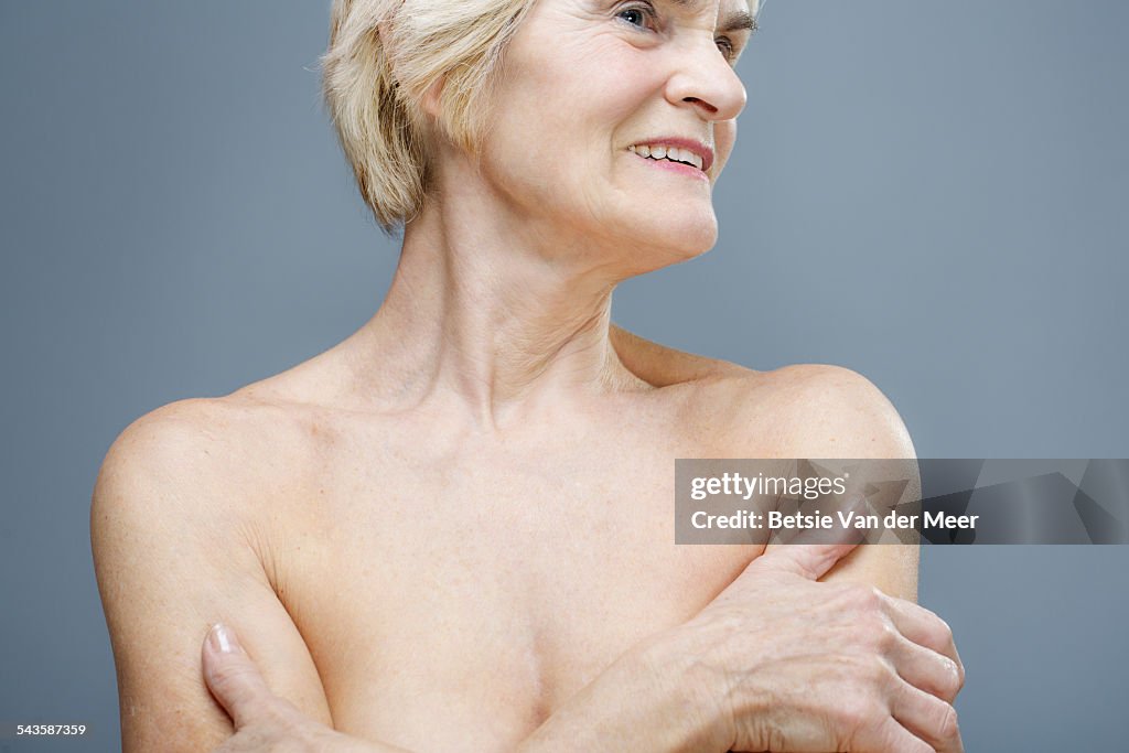 Close up of senior woman with bare shoulders.