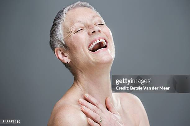 senior woman laughing,with bare shoulders. - beautiful bare women fotografías e imágenes de stock