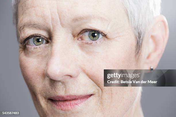 close up portrait of senior woman. - green eyes stockfoto's en -beelden