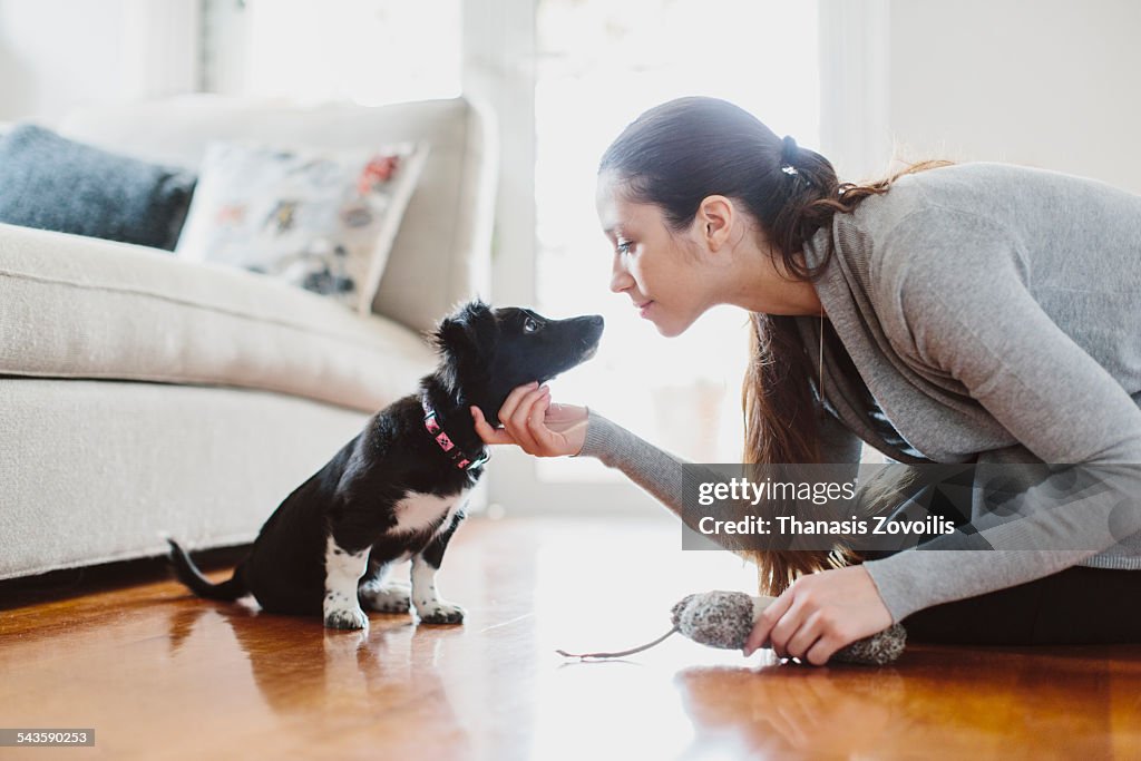 Young woman playing with her dog