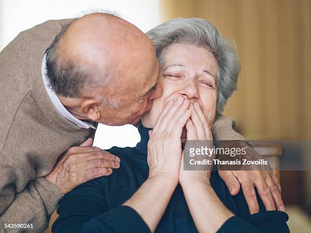 senior couple having fun - women kissing stock pictures, royalty-free photos & images