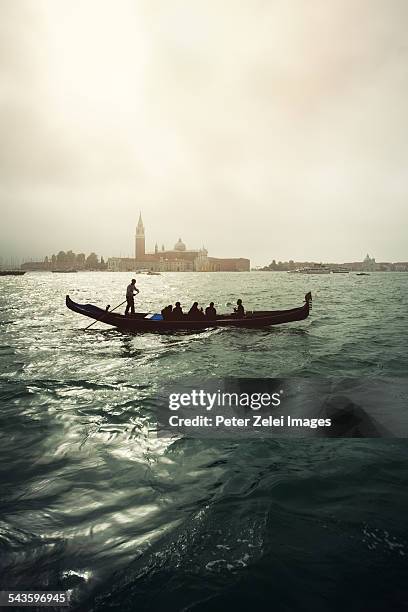 gondola on the venetian lagoon - venetian lagoon stock pictures, royalty-free photos & images