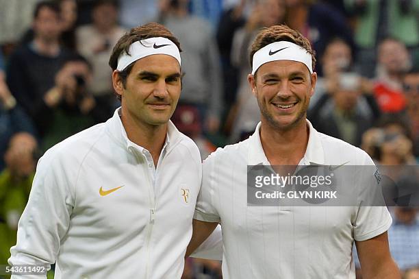 Britain's Marcus Willis poses with opponent Switzerland's Roger Federer at the start of their men's singles second round match on the third day of...