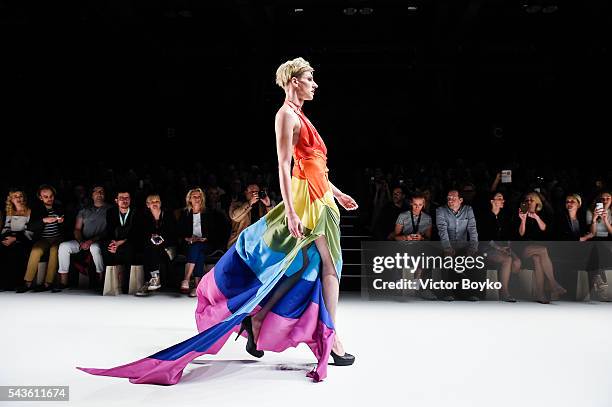 Male model dressed in a rainbow colour outfit walks the runway at the Anja Gockel show during the Mercedes-Benz Fashion Week Berlin Spring/Summer...