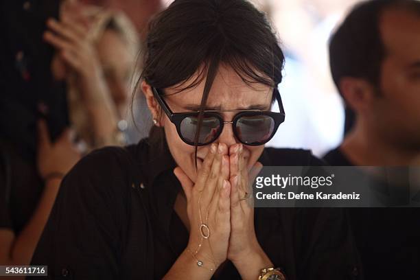 Relatives of 27-year-old flight officer Gulsen Bahadir, a victim of yesterdays attack on Istanbul Ataturk airport, mourn at her Turkish flag-draped...