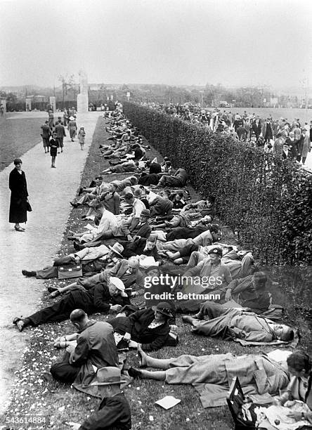 Rather than journey back to their homes in the city proper, these spectators at the Olympics, enjoyed their lunch on the grounds of the Olympic...