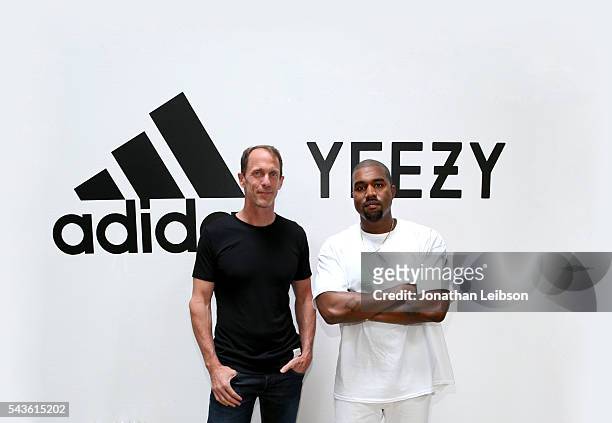 Adidas CMO Eric Liedtke and Kanye West at Milk Studios on June 28, 2016 in Hollywood, California. Adidas and Kanye West announce the future of their...