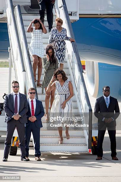 First Lady Michelle Obama, her mother Marian Shields Robinson and her daughters Malia Obama and Sasha Obama arrive at Torrejon Air Force Base on June...