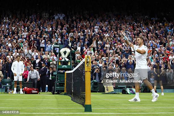 Marcus Willis of Great Britain applauds supporters following defeat during the Men's Singles second round match against Roger Federer of Switzerland...