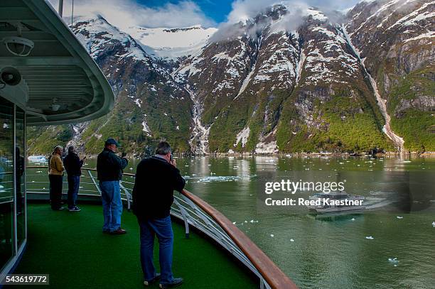 tourists watch an approaching boat from a cruise ship in alaska - spartan cruiser stock pictures, royalty-free photos & images