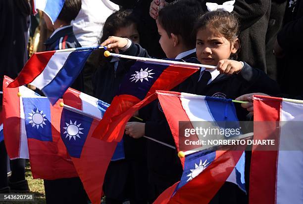 Schoolgirl waves flags of Taiwan and Paraguay during the visit of Taiwan's President Tsai Ing-wen to the General Andres Rodriguez school to which the...