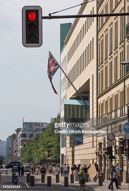 Exterior view of the British Embassy in Berlin and a red traffic light.