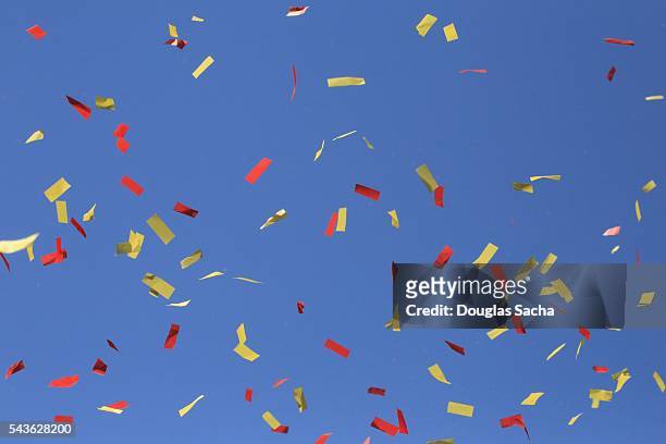 parade confetti falls against the clear blue sky - thanksgiving parade stock pictures, royalty-free photos & images