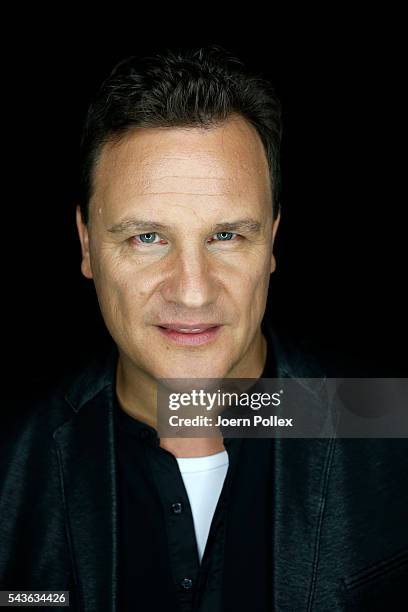 Designer Guido Maria Kretschmer poses for photographs backstage ahead of his show during the Mercedes-Benz Fashion Week Berlin Spring/Summer 2017 at...