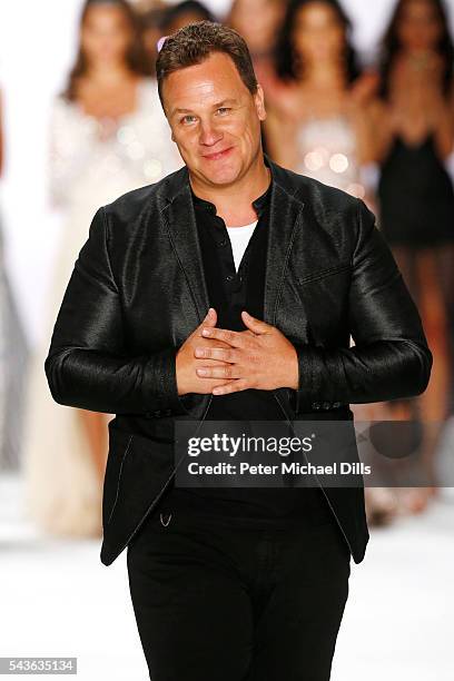 Designer Guido Maria Kretschmer acknowledges the applause of the audience at the runway after his show during the Mercedes-Benz Fashion Week Berlin...