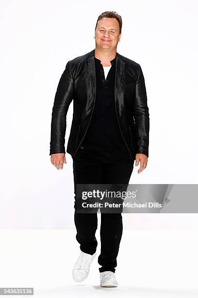 Designer Guido Maria Kretschmer acknowledges the applause of the audience at the runway after his show during the Mercedes-Benz Fashion Week Berlin...