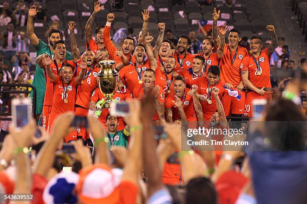 Chile players celebrate their victory at the trophy presentation after their penalty shoot out win during the Argentina Vs Chile Final match of the...
