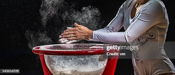 close up of female gymnast chalking his hands - gymnastics stock pictures, royalty-free photos & images