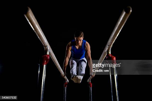 male gymnast on parallel bars - parallel bars gymnastics equipment 個照片及圖片檔