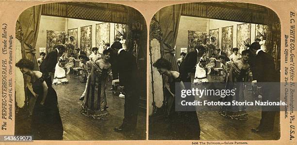 In a ballroom couples of dancers greet each other with a bow at the end of a dance. Stereophoto, H. C. White CO, , N. Bennington VT 1903.