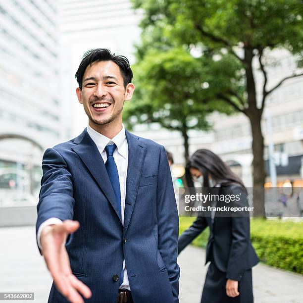businessman give the handshake in osaka - japanese greeting stock pictures, royalty-free photos & images