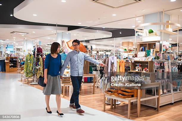 young couple in a department store - retail interior stock pictures, royalty-free photos & images