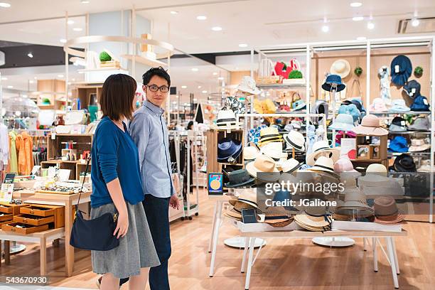 young couple in a department store - lypsekyo16 stockfoto's en -beelden