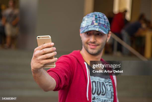 Man taking selfie with his new and first iPhone 6 sold on Barcelona city in front the Apple Store. Catalonia, Europe.