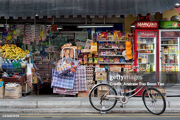 Old world charm of Little India, Singapore, with its traditional grocers stocked with provisions along alleys with bicycles. August 2014.