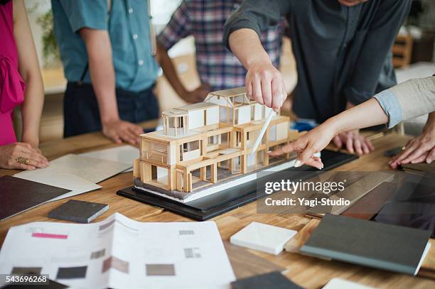 team of interior designers discussing in the studio - architectural model stockfoto's en -beelden